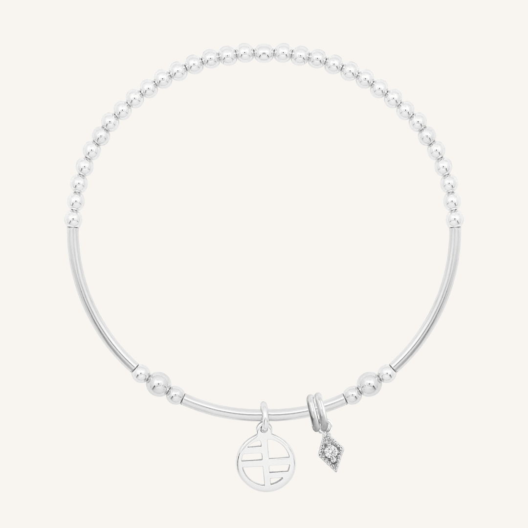 A silver-tone charm bracelet with a petite diamond charm and a stretchy bead chain.