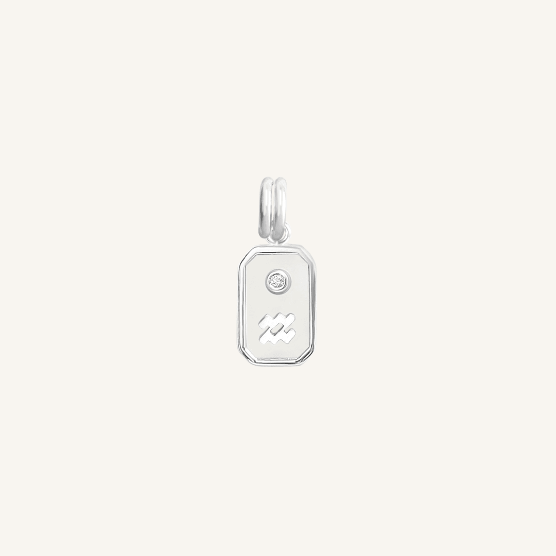 A silver rectangular shaped charm with the Aquarius zodiac symbol on it, designed with an iridescent finish.