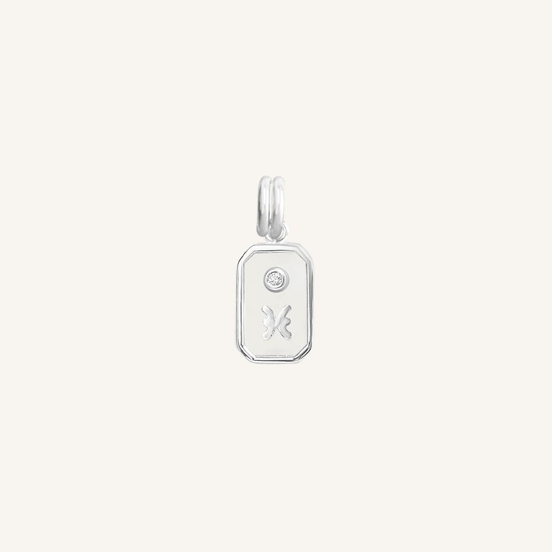 A silver rectangular shaped charm with the Pisces zodiac symbol on it, designed with an iridescent finish.