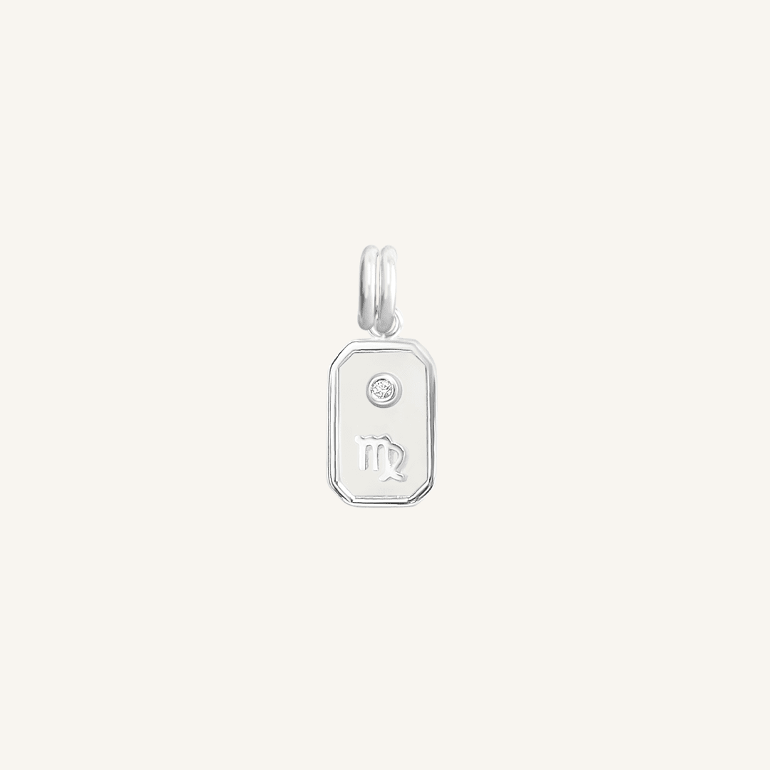 A silver iridescent zodiac charm representing the Virgo sign, with a loop for attachment, displayed against a white background.