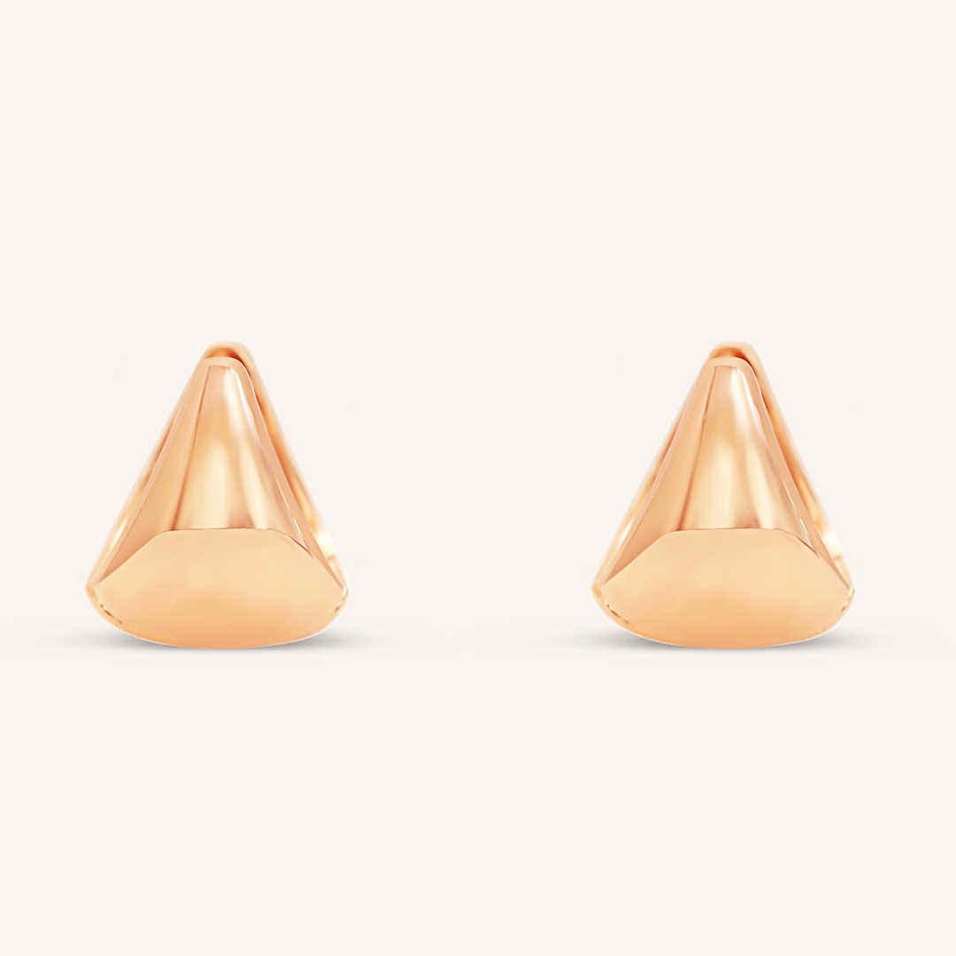 A pair of rose huggie hoop earrings on a white background.