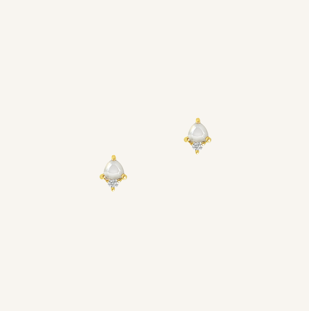 Pair of gold and pearl earrings on a white background