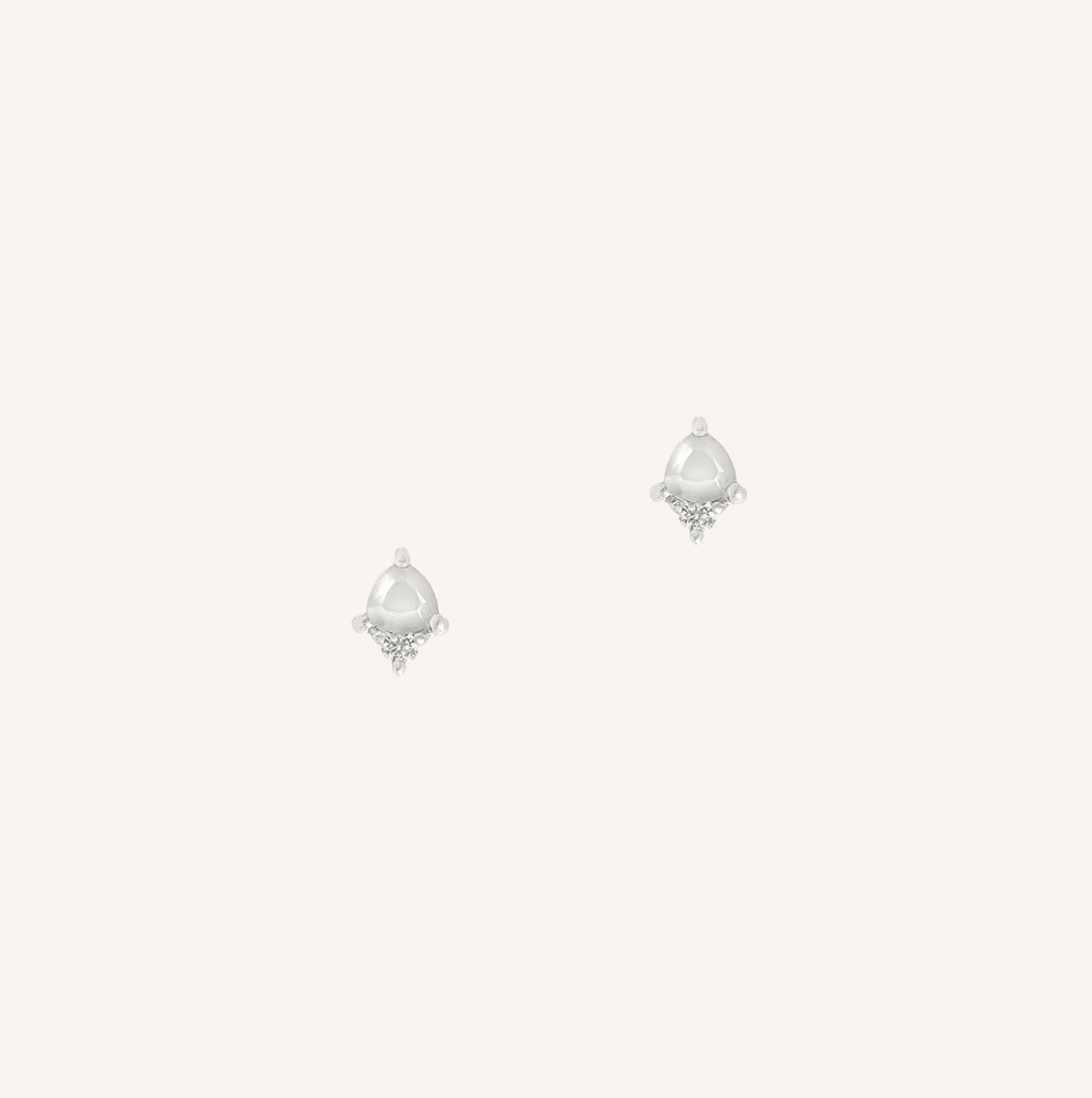 Pair of silver earrings with teardrop-shaped gemstones on a white background
