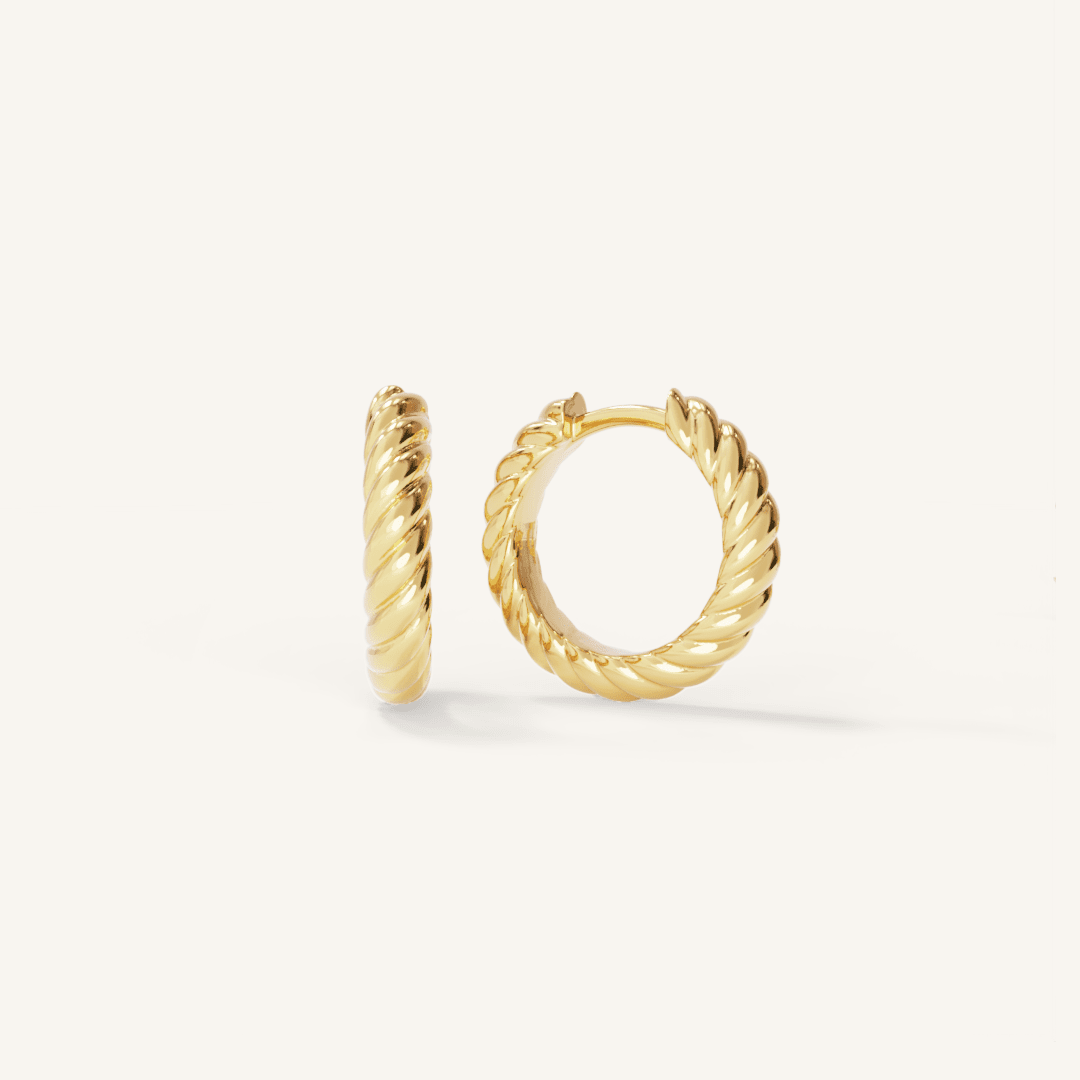 gold delicate hoops with a twist design on white background