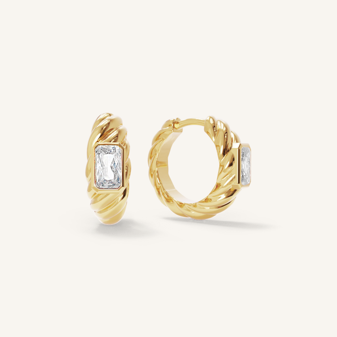 gold hoops inspired by the Louvre's architecture with Marquise cut white cubic zirconias bezel set on white background