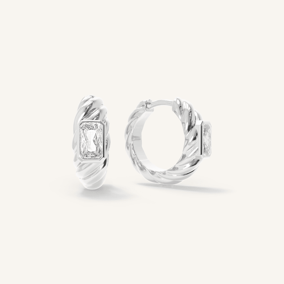 silver hoops inspired by the Louvre's architecture with Marquise cut white cubic zirconias bezel set on white background
