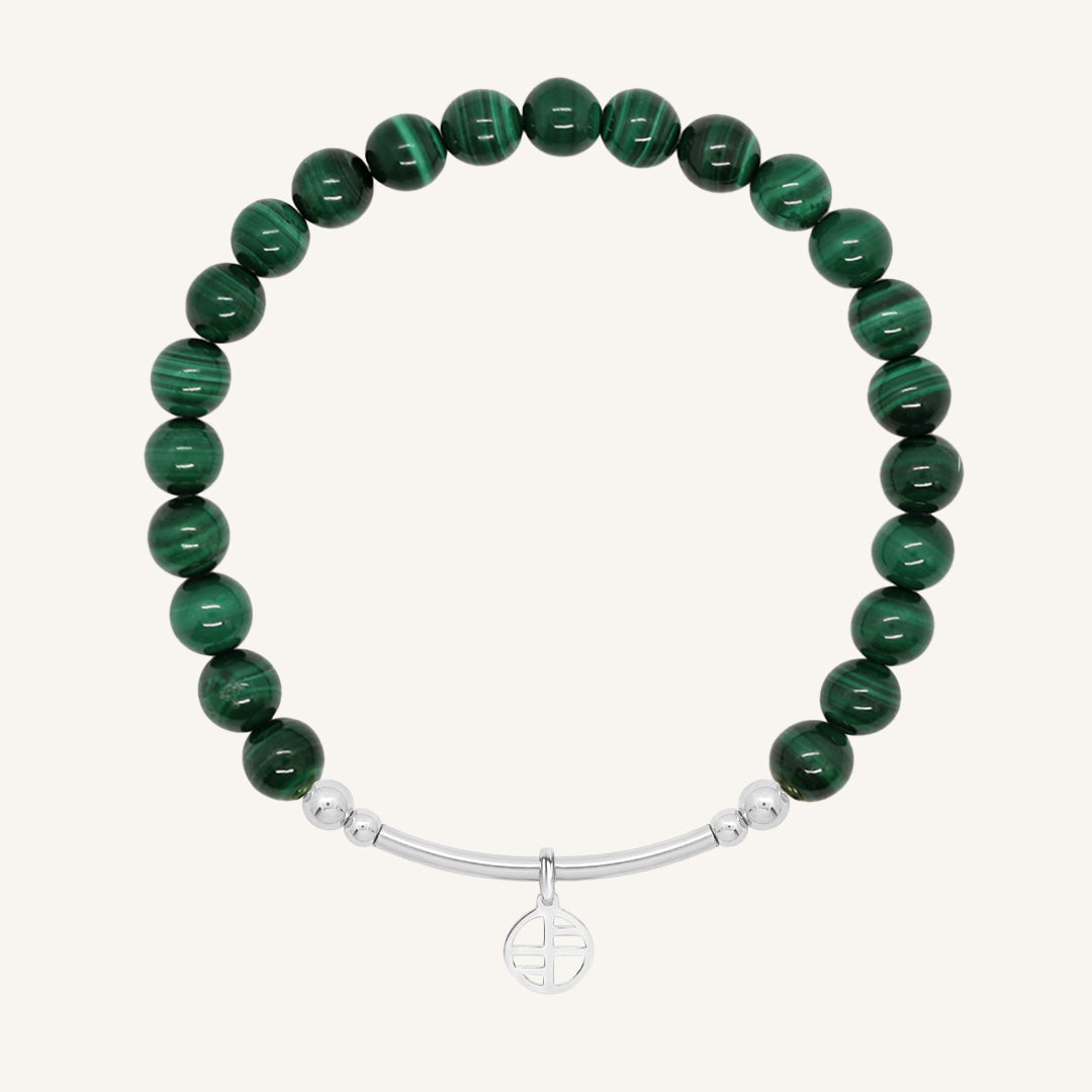 Green beaded bracelet with a silver bar on a white background