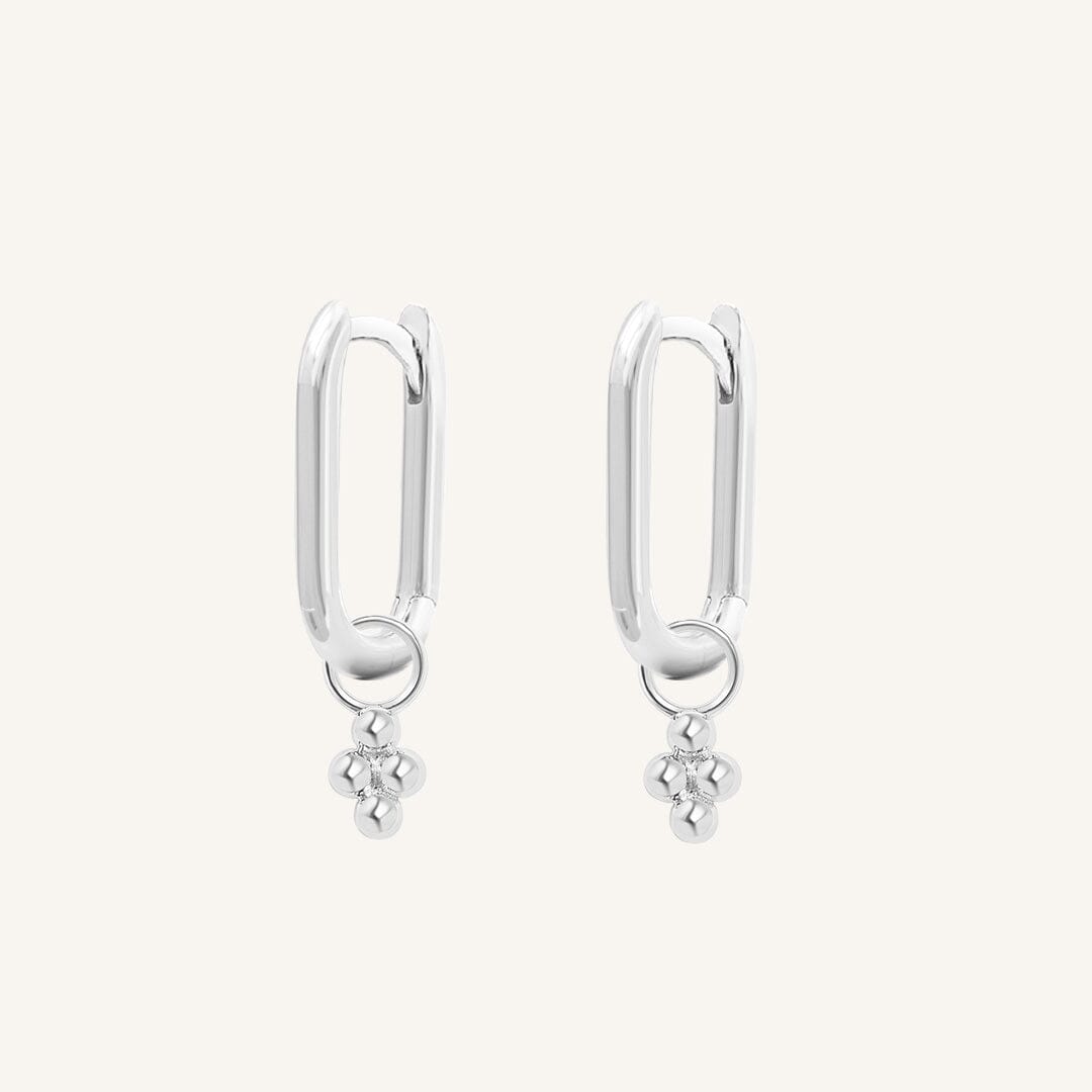A pair of silver-colored rectangle hoop earrings with petite bobble details.