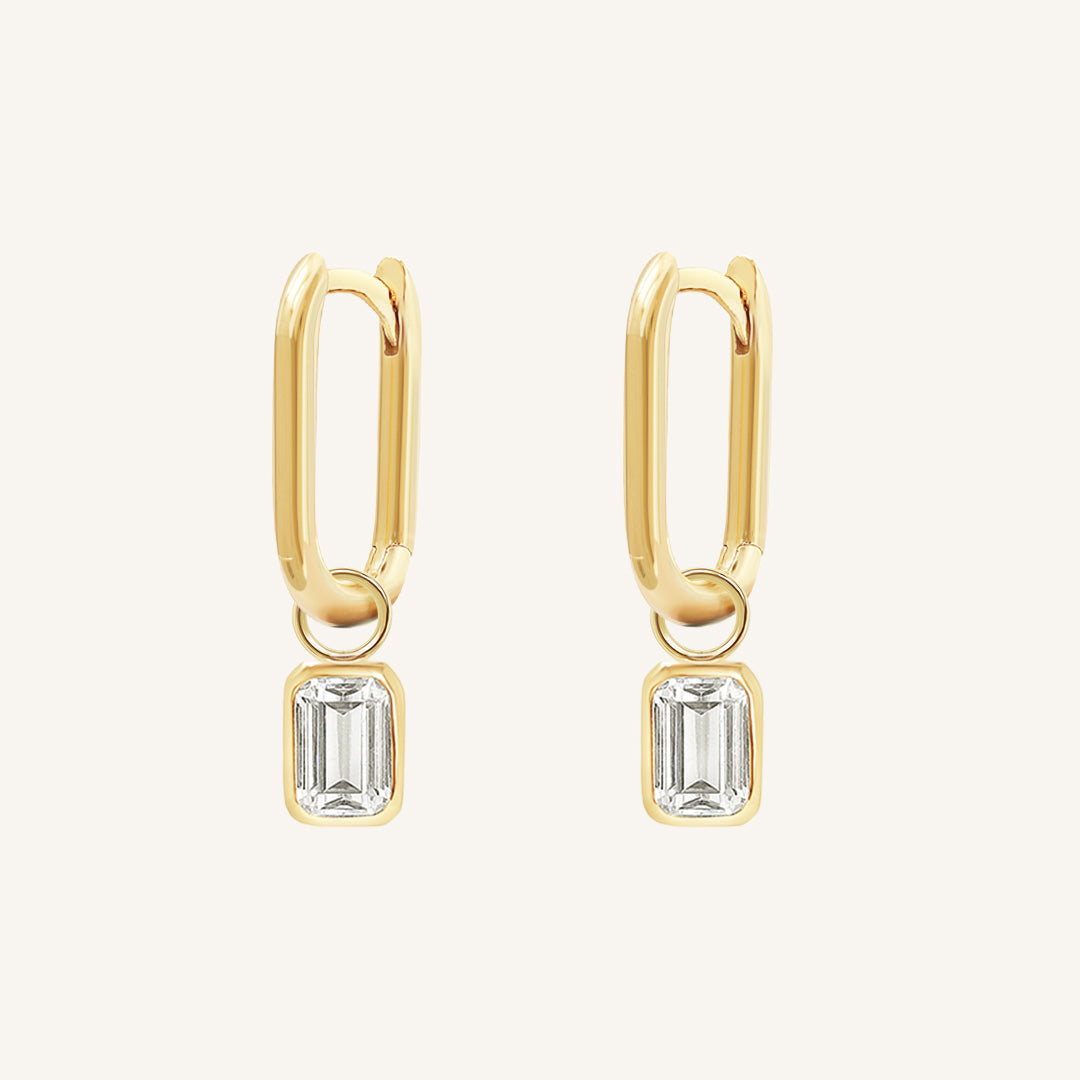 A rectangular pair of hoop charms with cubic zirconias attached to hoops