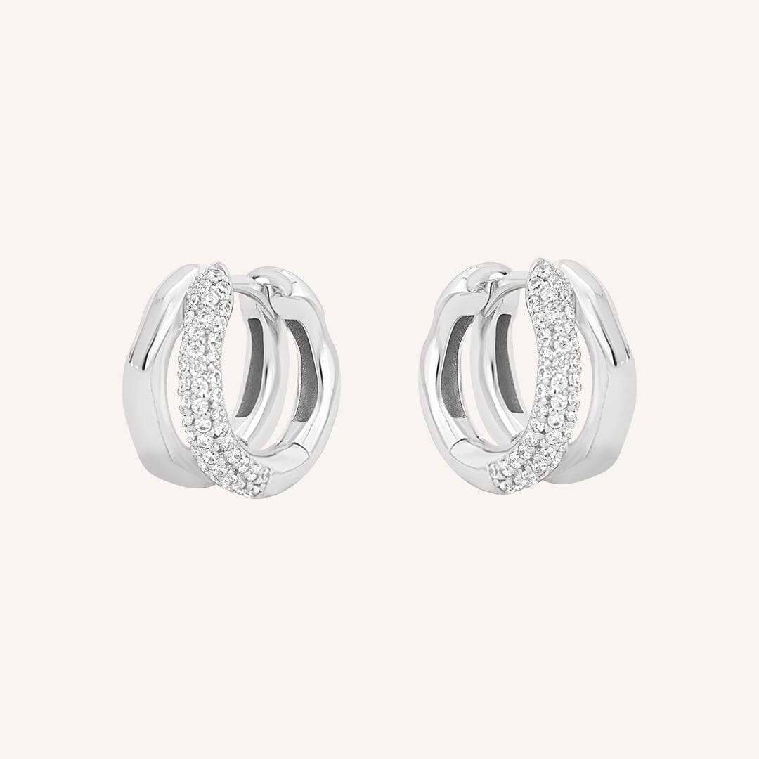 A pair of coloured hoop earrings with a huggie design, featuring a layered look.