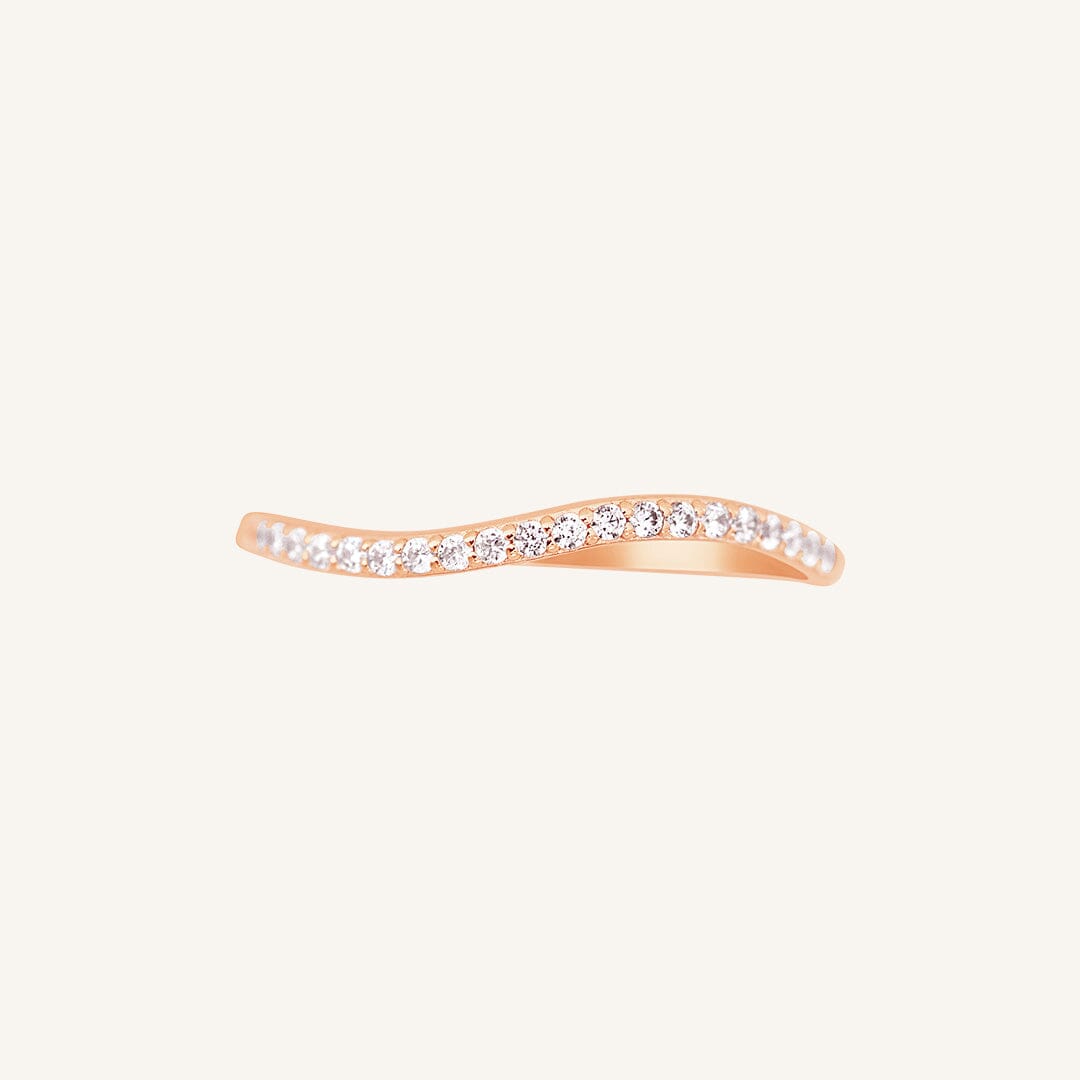A slim, elegant ring with multiple small cubic zirconias set in a rose gold coloured band.
