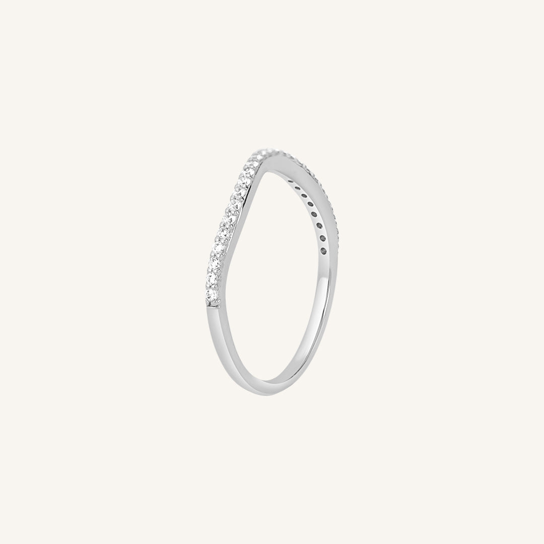 A slim, elegant ring with multiple small cubic zirconias set in a silver coloured band.