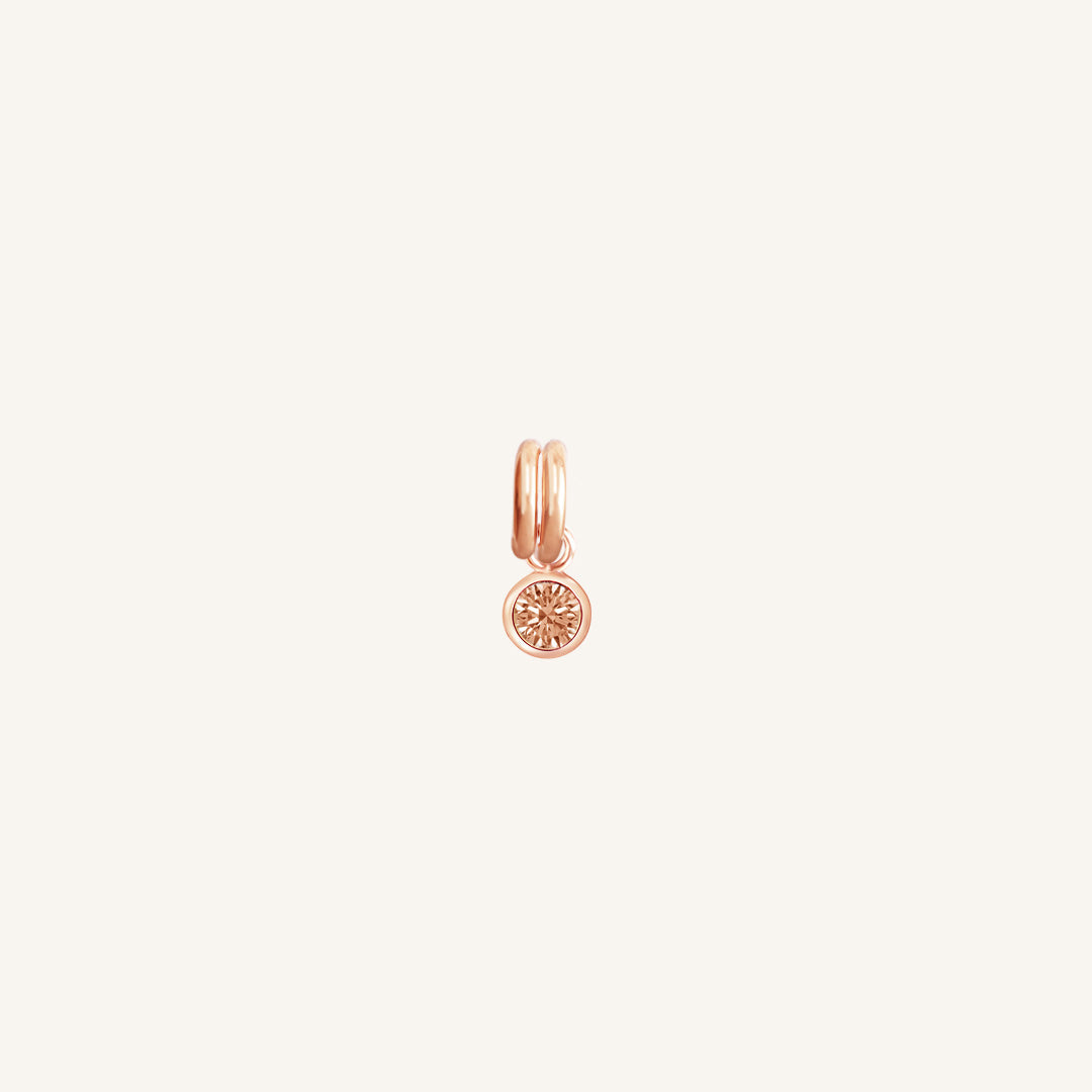 A round rose gold birthstone charm with a citrine cubic zirconia, symbolising the November birth month.
