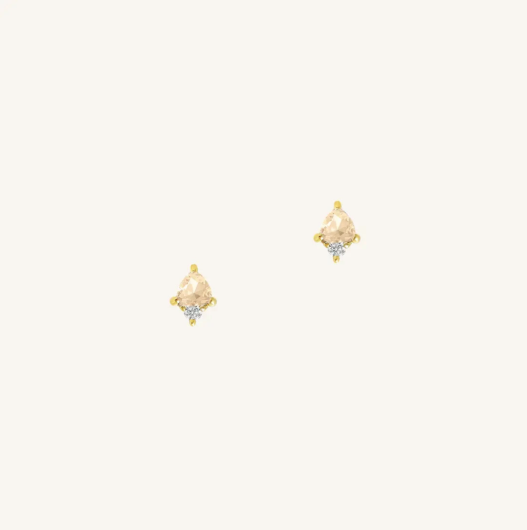 A gold pair of stud earrings featuring a citrine cubic zirconia, representing November.