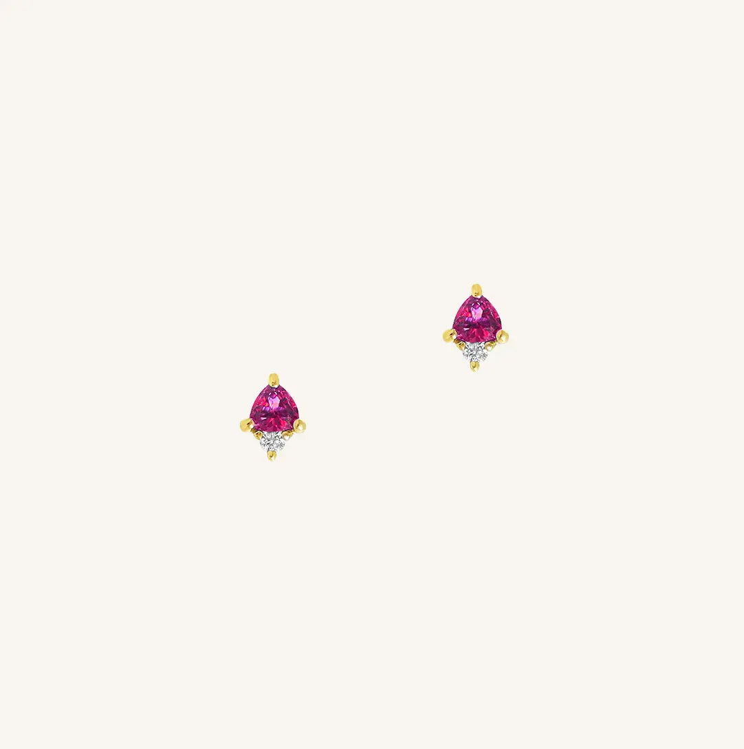 A gold pair of stud earrings featuring a pink cubic zirconia, representing October.