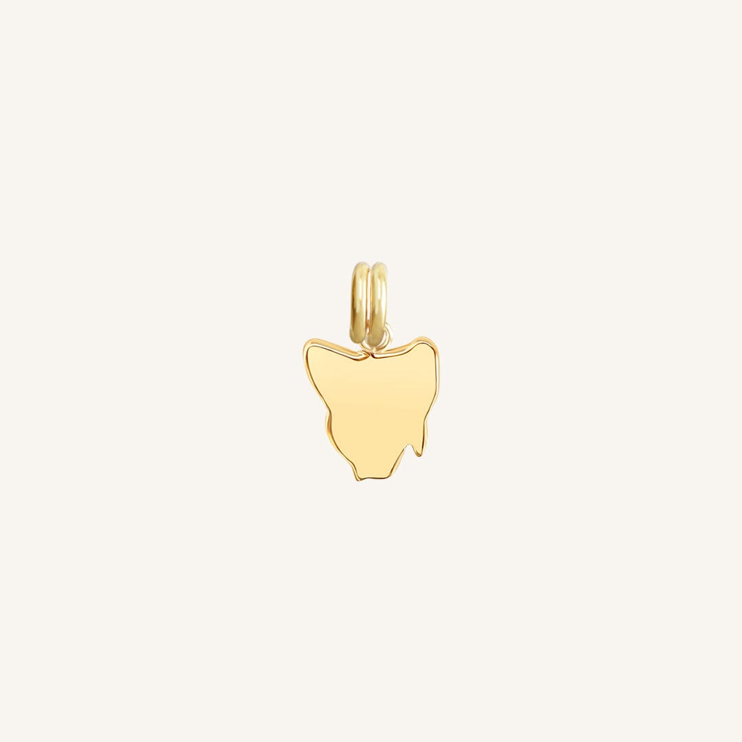A gold-colored charm in the shape Tasmania