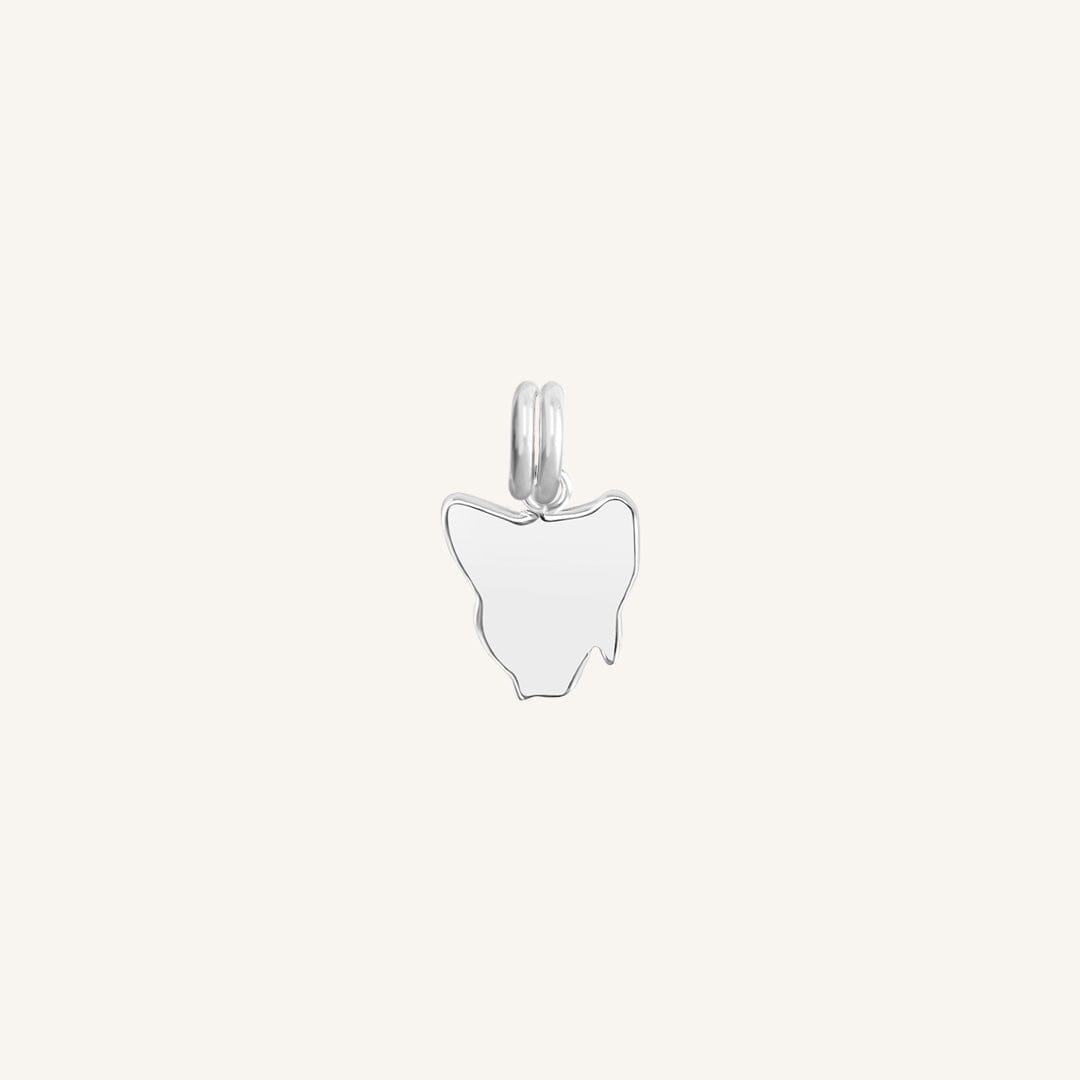 A silver-colored charm in the shape Tasmania