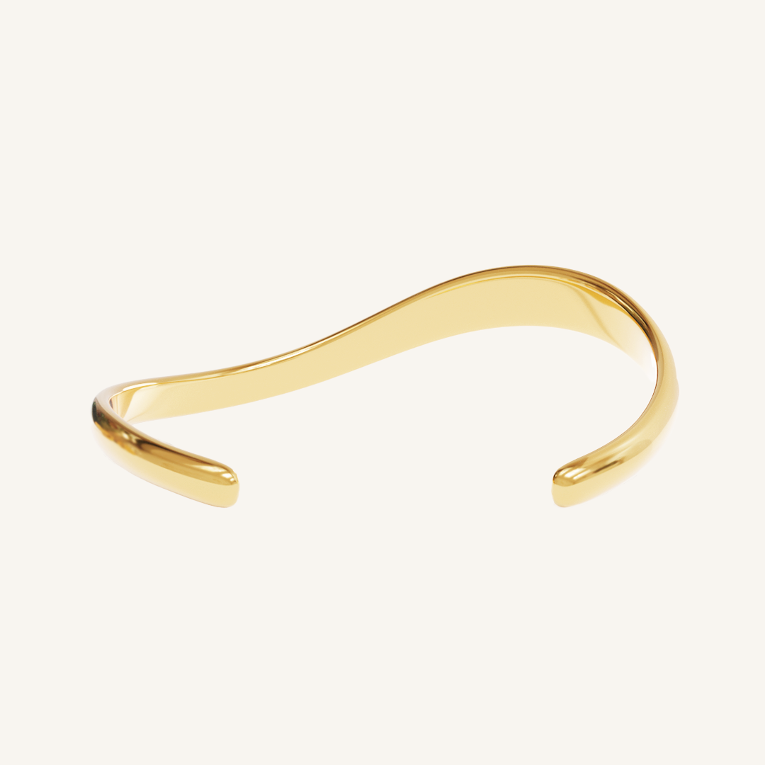 Gold cuff asymmetrical in shape with Navy, white and red cubic zirconias in a row on white background back view