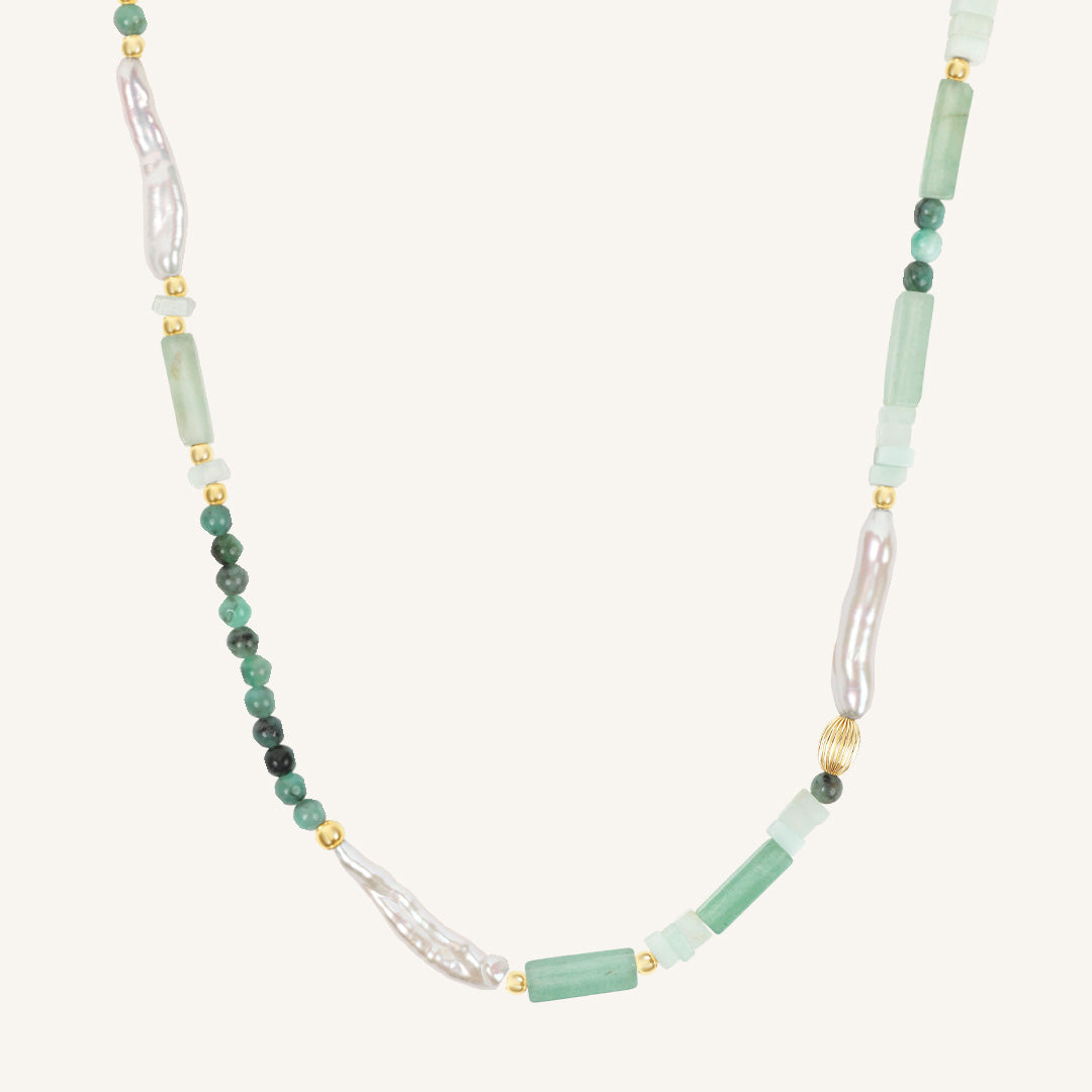 Necklace with green and white beads on a white background