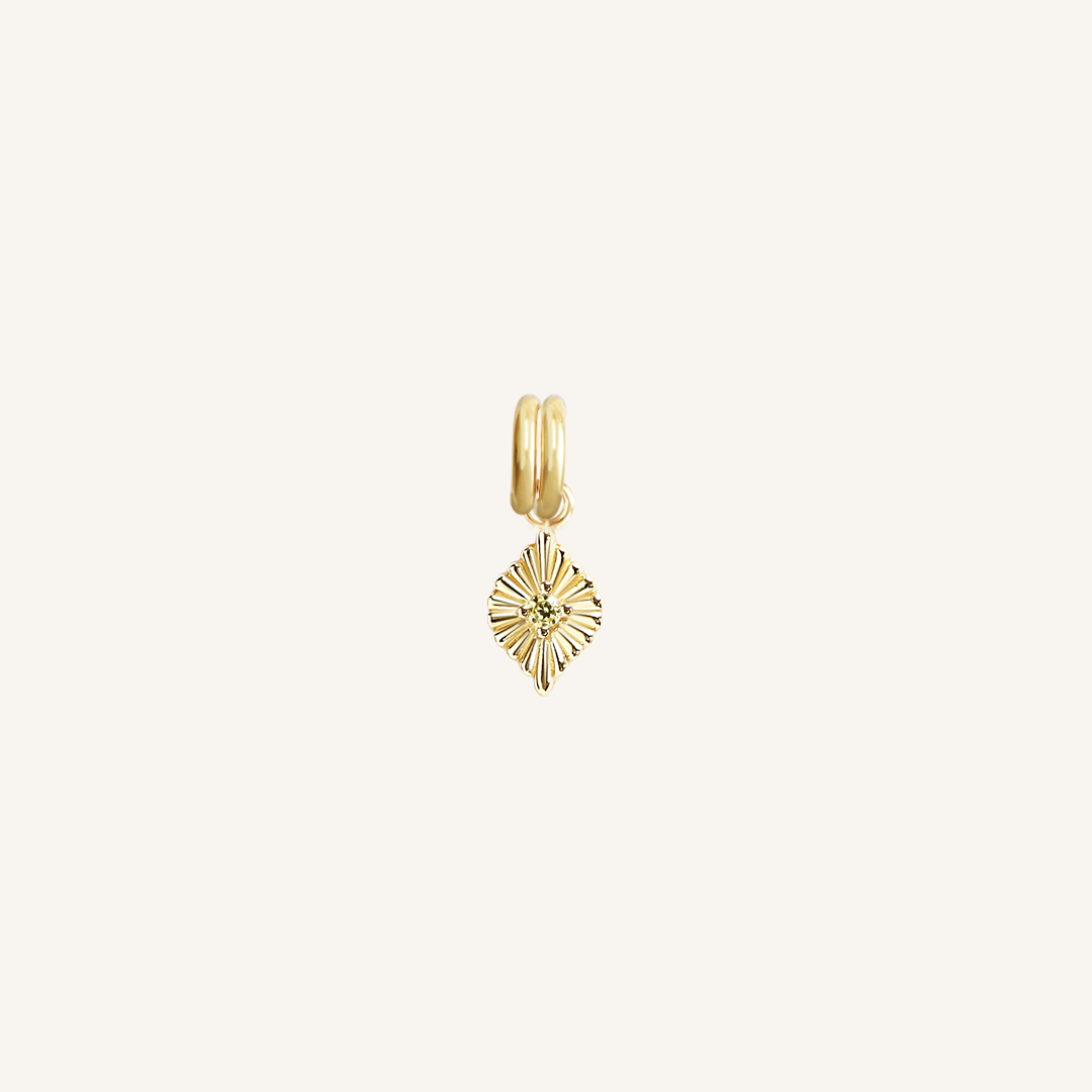 A gold birthstone charm with a peridot cubic zirconia representing the month of August.