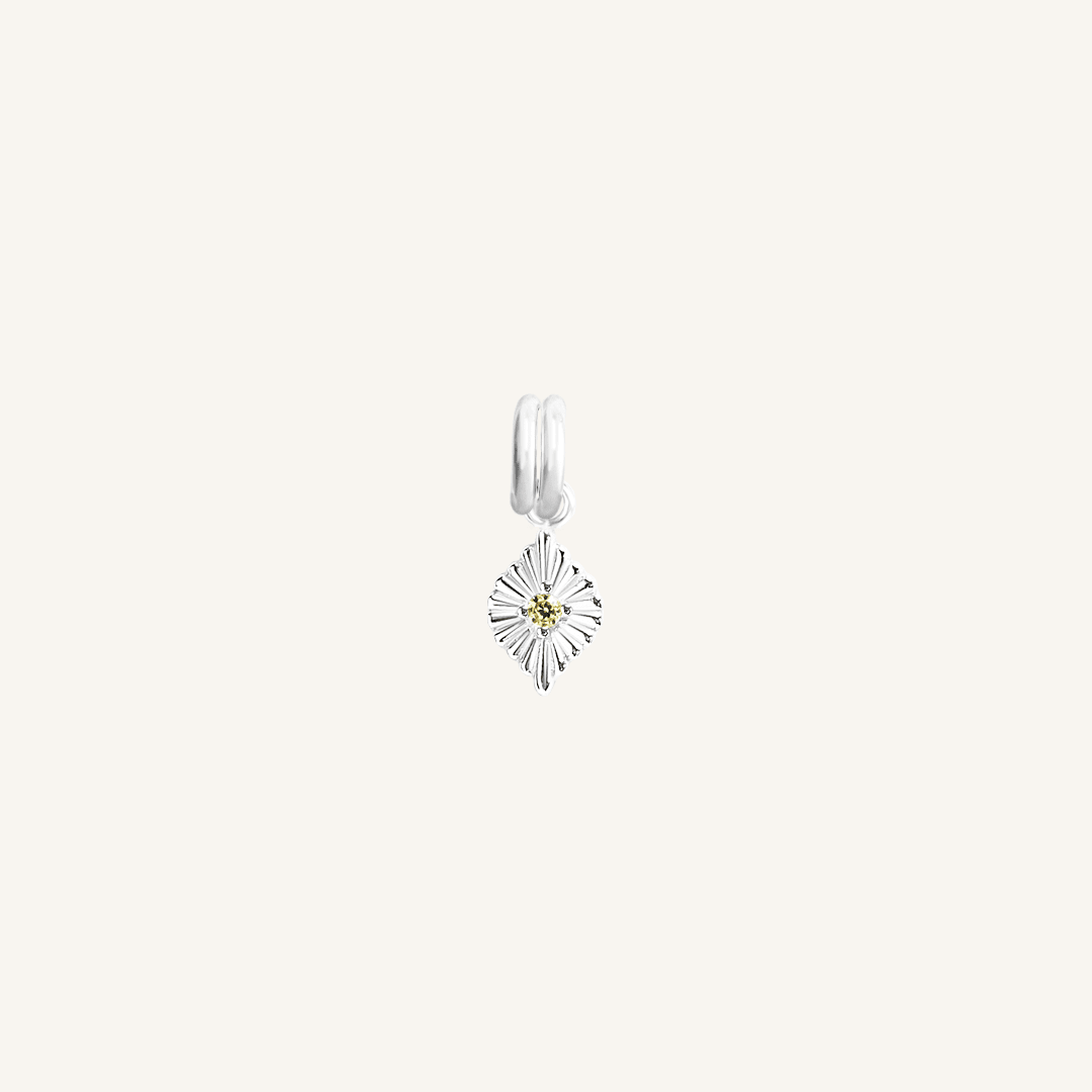 A silver birthstone charm with a peridot cubic zirconia representing the month of August.