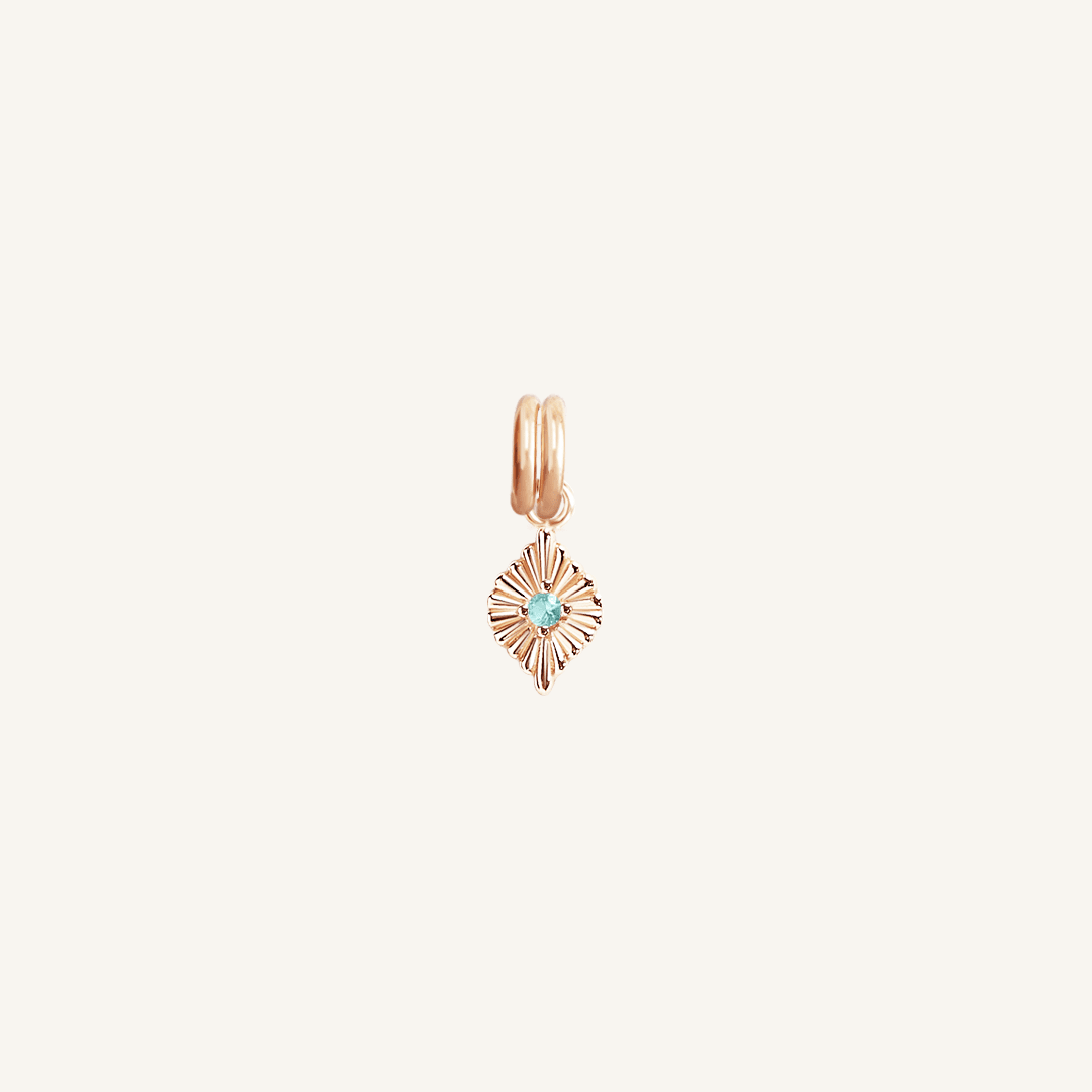 A rose birthstone charm with a blue cubic zirconia representing the month of December.