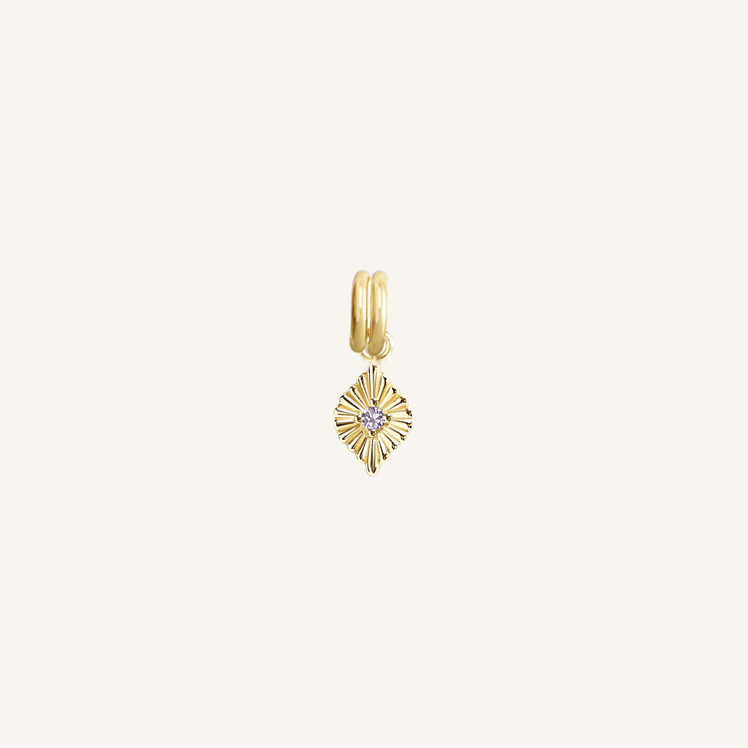 A gold birthstone charm with a purple cubic zirconia representing the month of February.