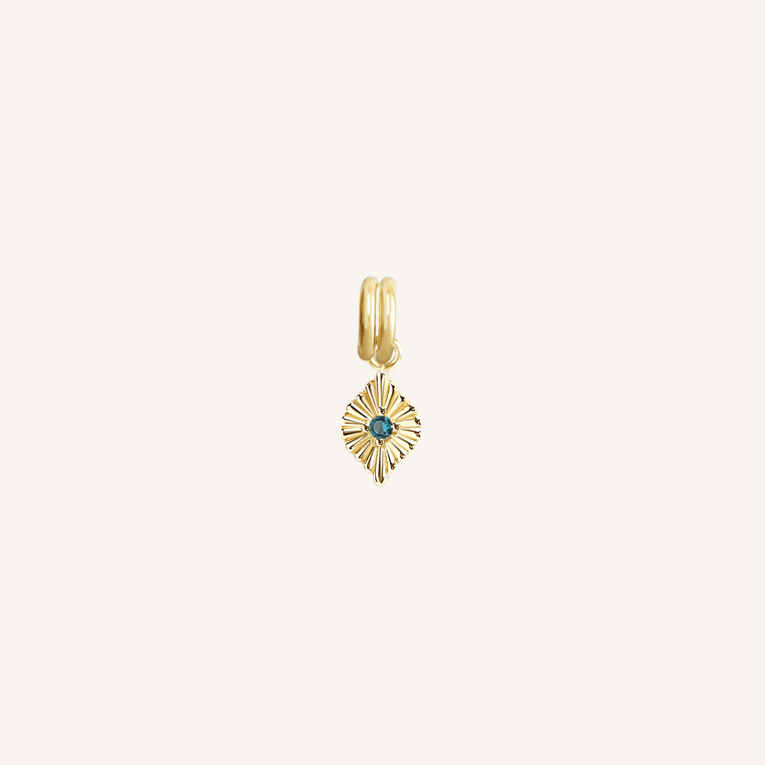 A gold-colored petite birthstone charm with a blue gemstone, symbolizing September.