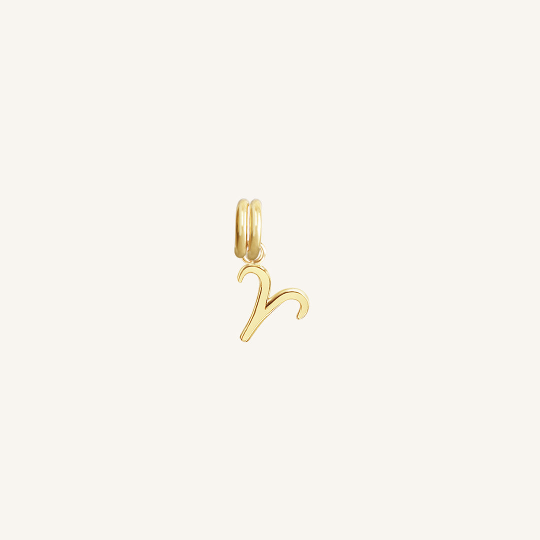 A gold Petite Zodiac Charm representing the Aries sign.