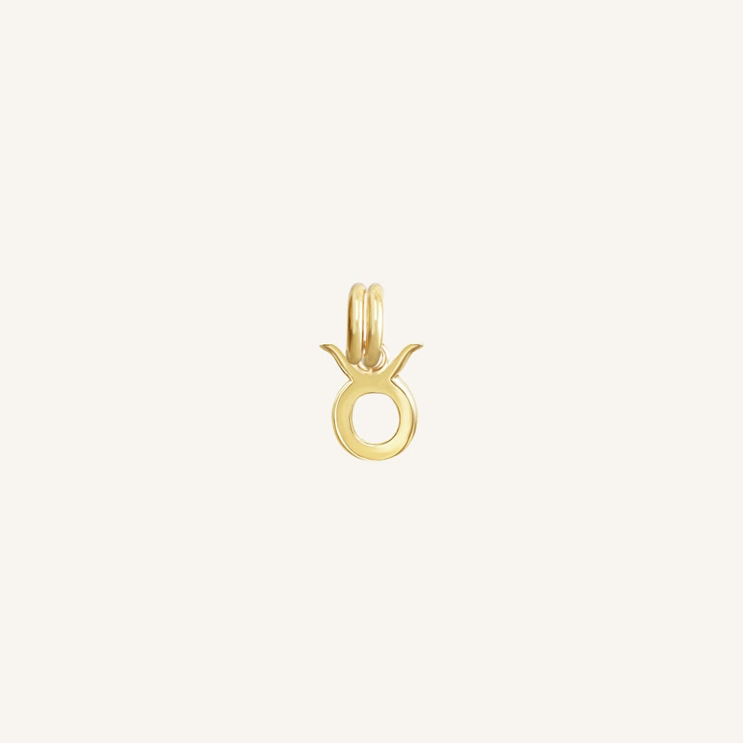 A gold-coloured Petite Zodiac Charm representing the Taurus sign.