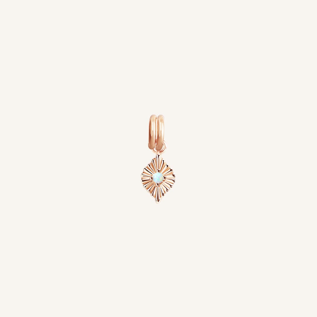 A rose diamond shaped charm with a faux opal in the centre, designed to be attached to a bracelet or necklace