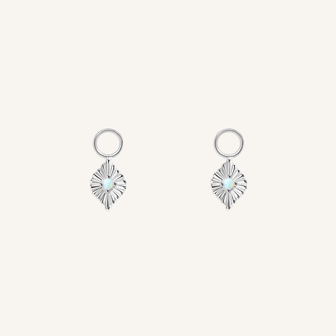 A pair of silver diamond shaped hoop charms featuring a faux opal