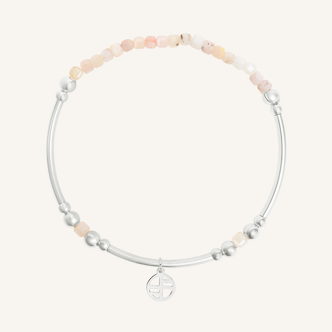 Bracelet with pink and silver beads on a white background