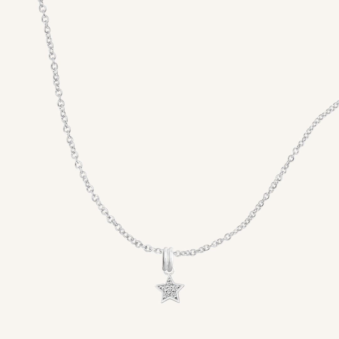 A silver necklace featuring a star-shaped charm pendant with cubic zirconias in the centre.