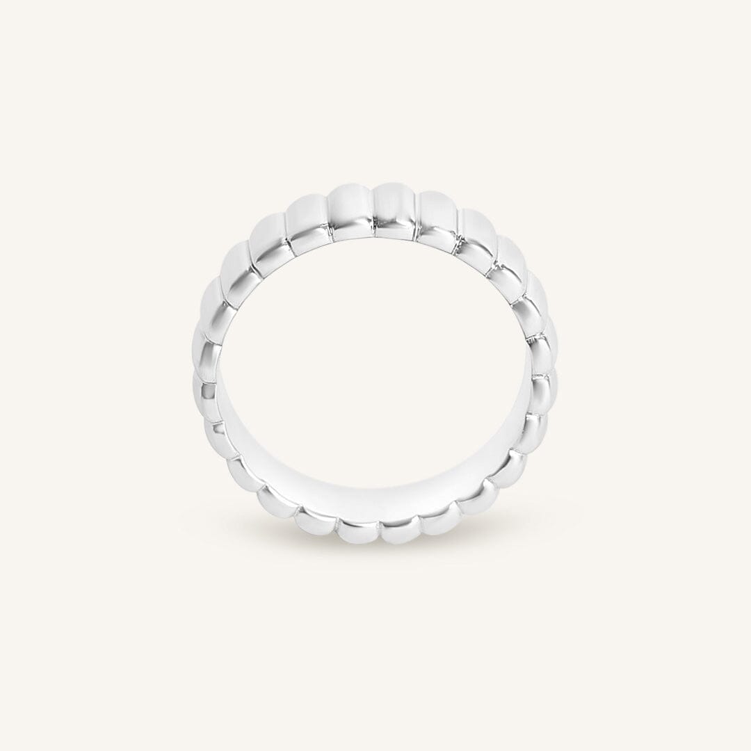 Silver ring with beaded design on a white background