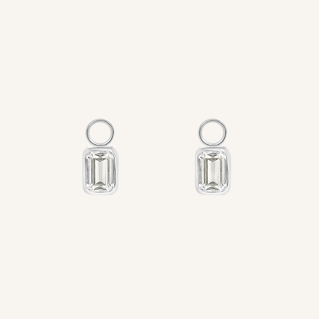 A pair of hoop charms with cubic zirconias designed to be added to hoop earrings.