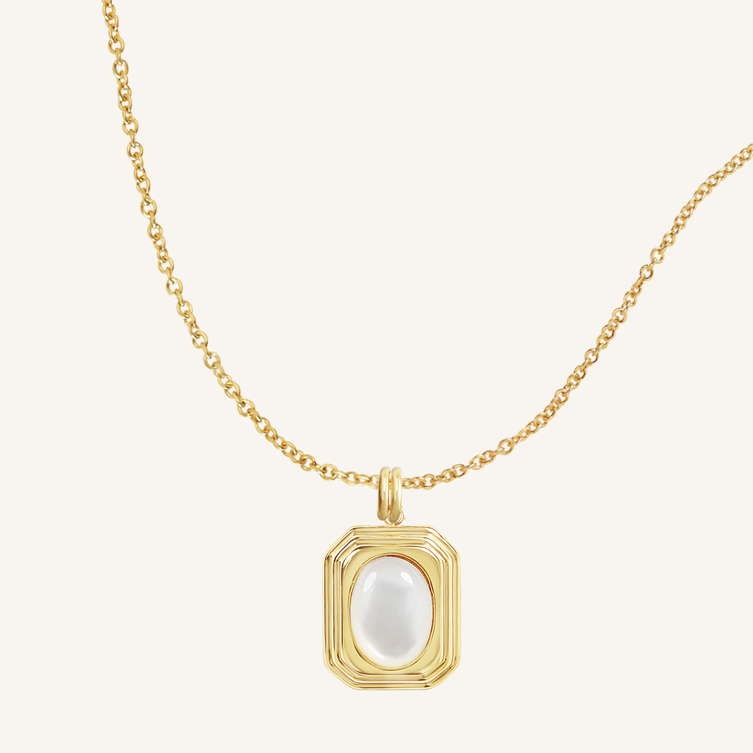 A gold-colored necklace with a square-shaped pendant featuring a mother-of-pearl stone.