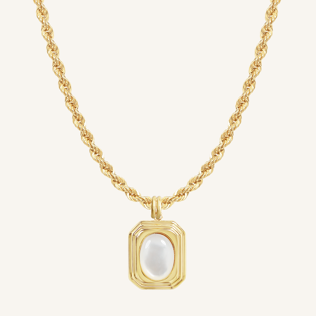 A gold-colored necklace with a square-shaped pendant featuring a mother-of-pearl stone.