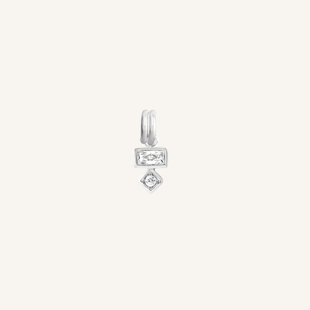 Petite silver charm with a rectangular and a round cubic zirconia, designed to be attached to a bracelet or necklace