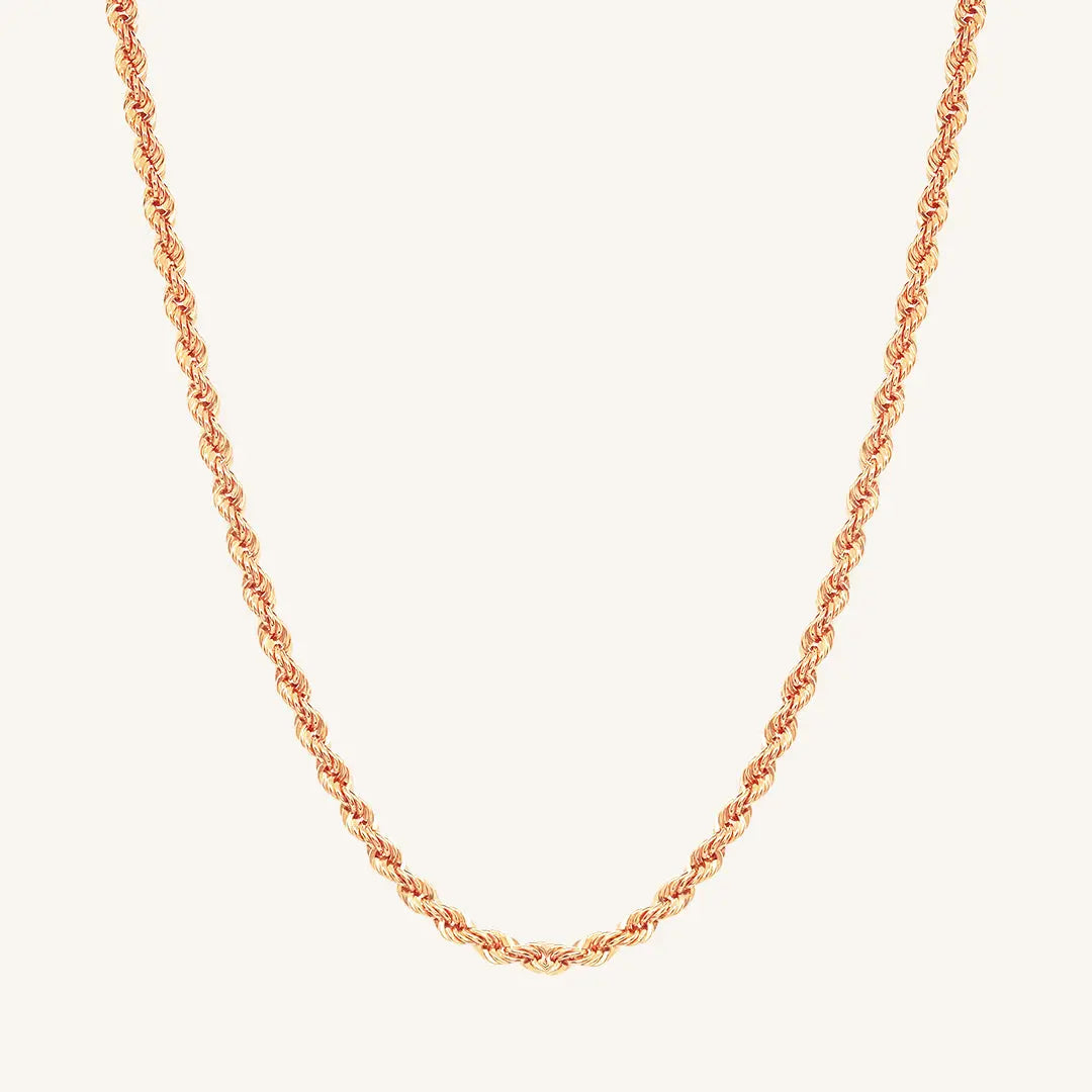 A rose rope chain necklace on a plain background.