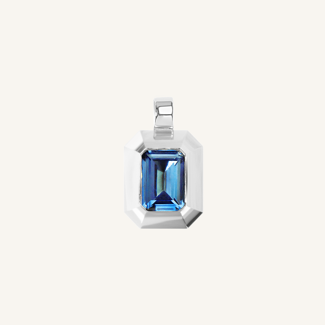 silver charm with Blue emerald cut cubic zirconia bezel set Inspired by the halls of Versailles on white background