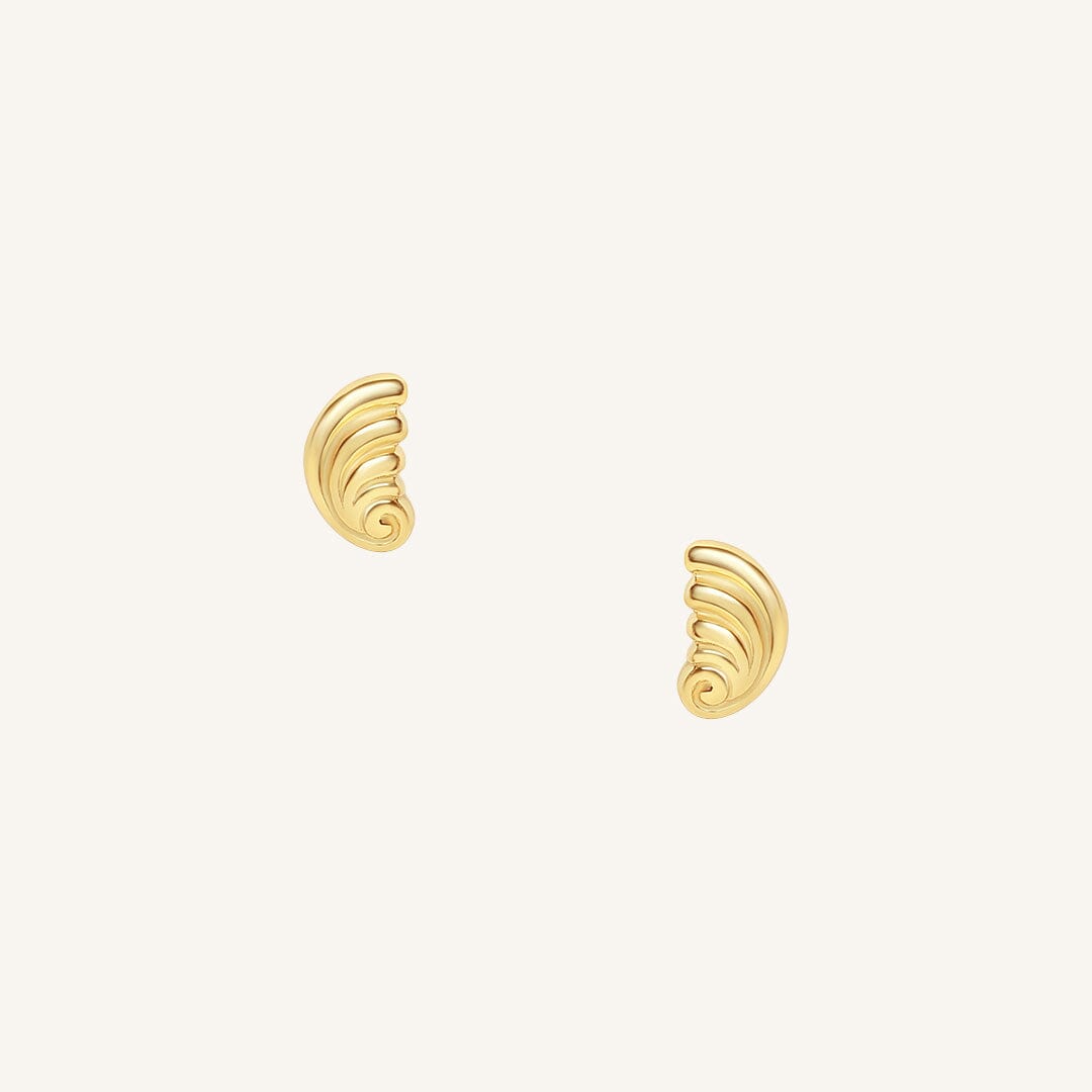Pair of gold spiral earrings on a white background