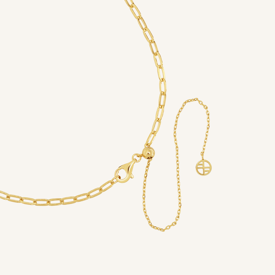 Close up on the adjustable clasp on the gold chain