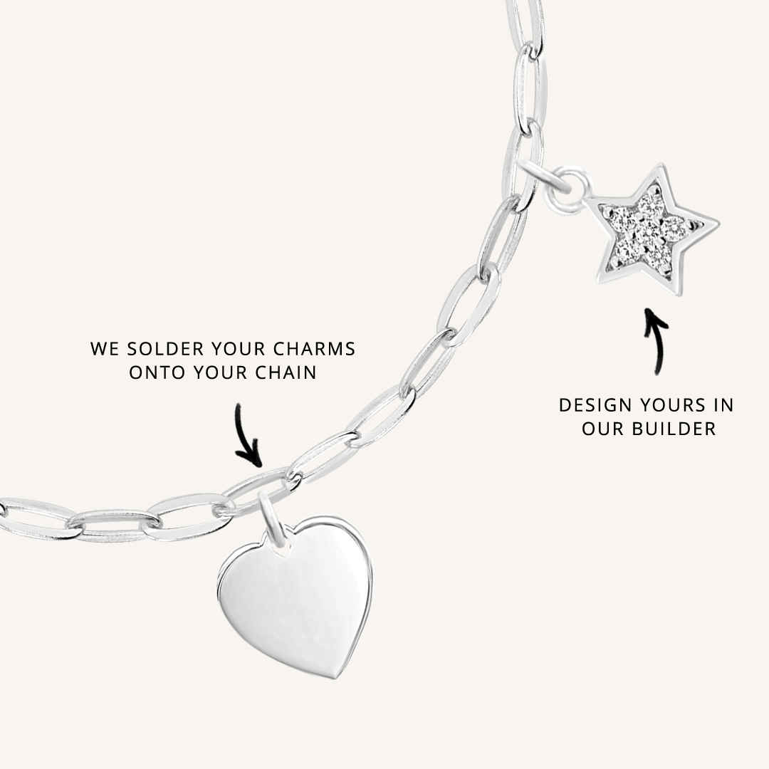 A silver chain necklace with paperclip links and multiple charms, showcasing where to solder charms and the option to choose the placement of the charms.