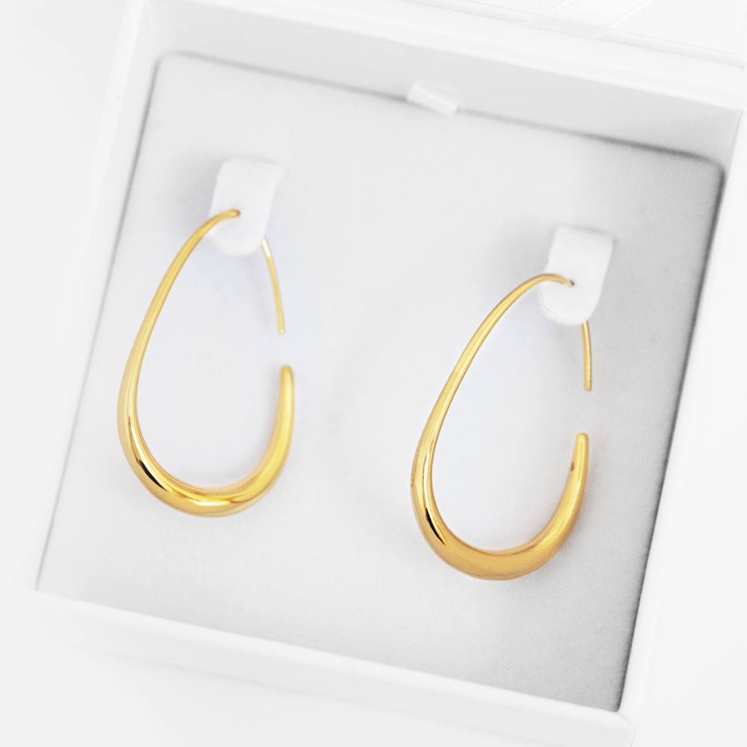 Gold hoop earrings on a white background
