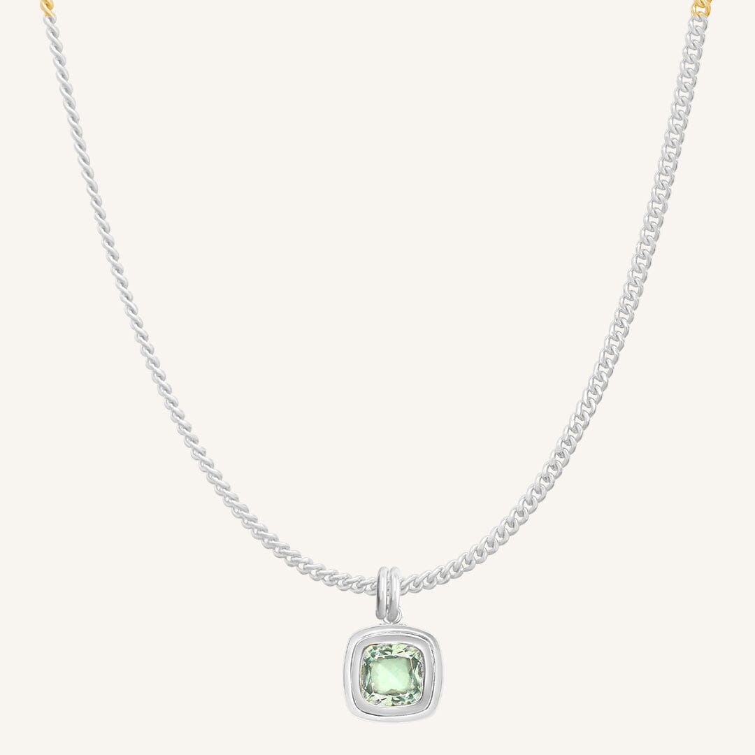 Necklace with a green gemstone pendant on a white background
