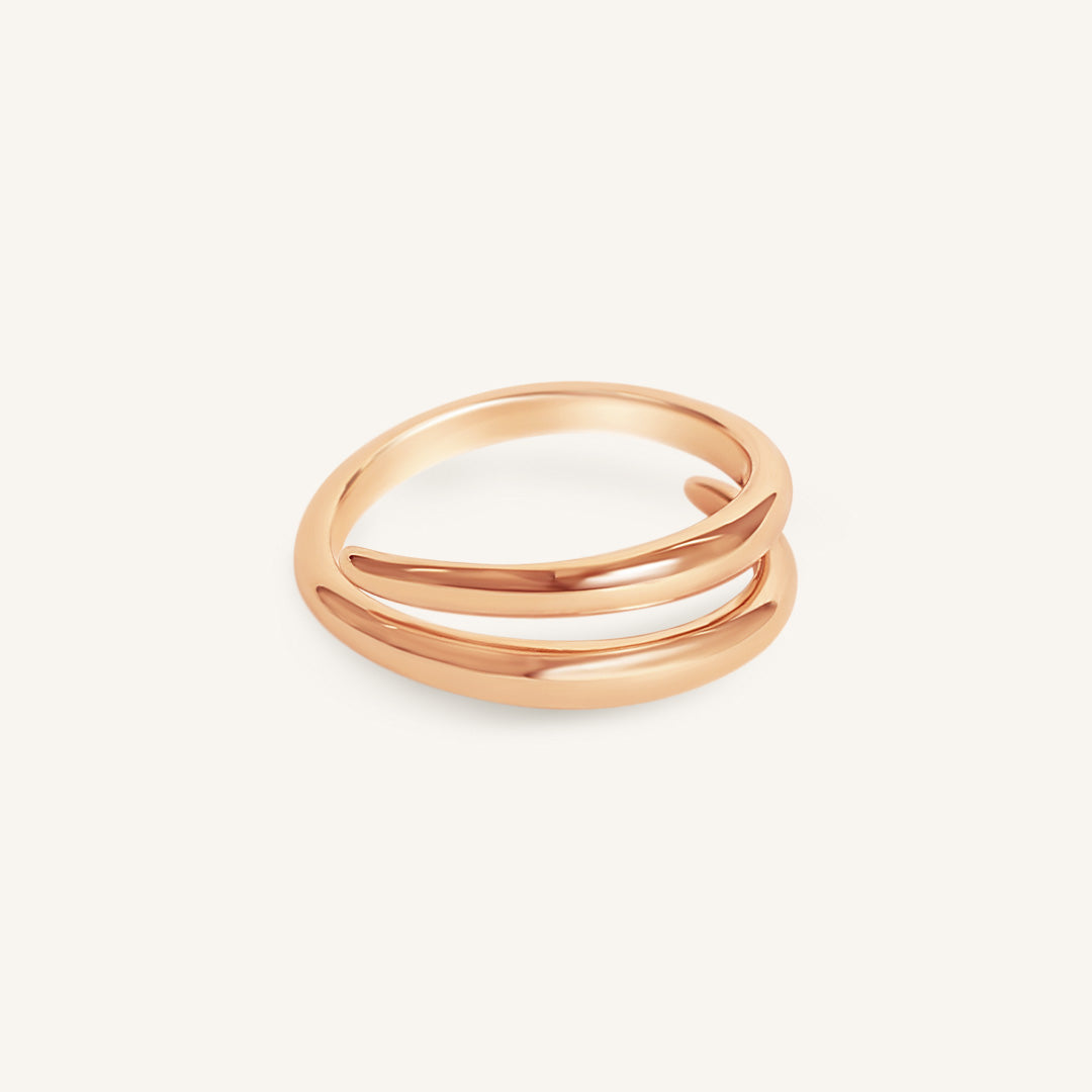 Rose gold ring with three bands on a white background