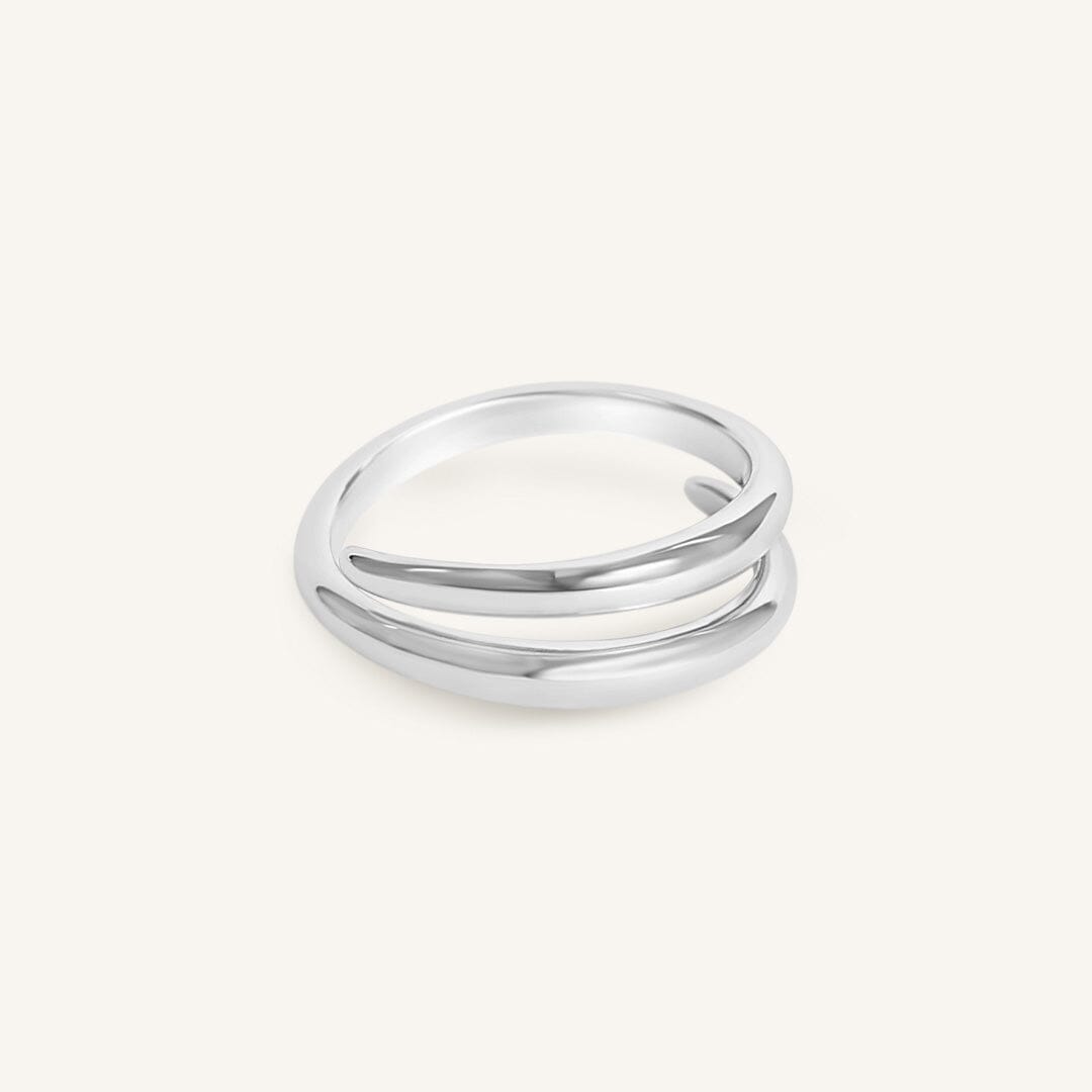 Silver ring with three bands on a white background