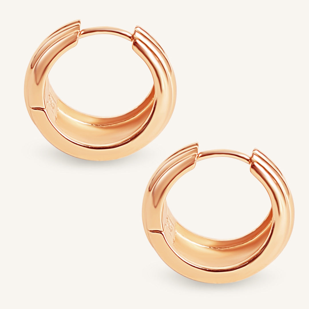 Rose gold hoop earrings on a light gray background
