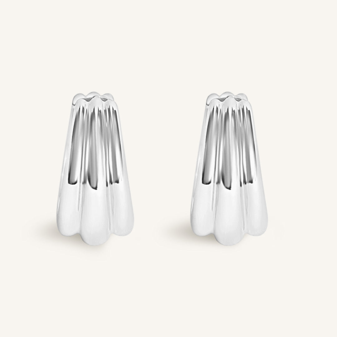 Two silver hoops on a light grey background